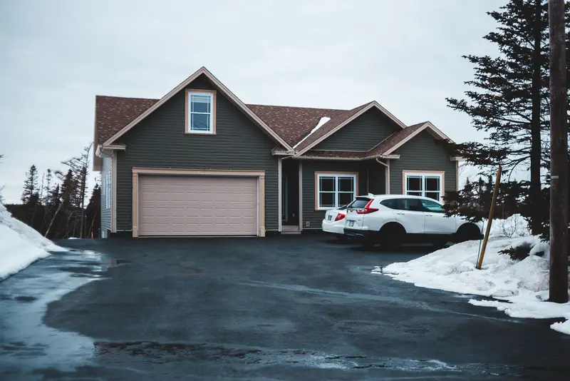 Garage door repair Forest Lake MN: house with an attached garage during a spring thaw