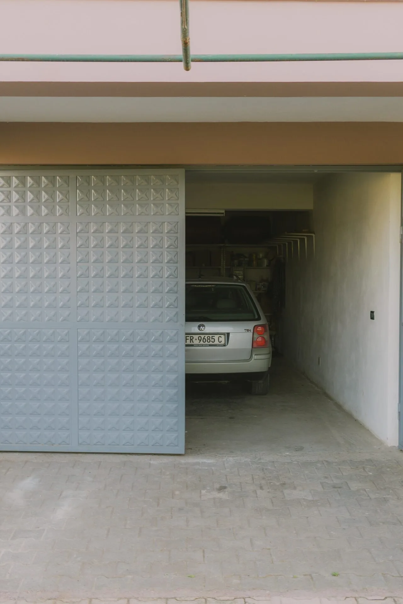 Garage door opener remote not working: car parked in a partially open residential garage