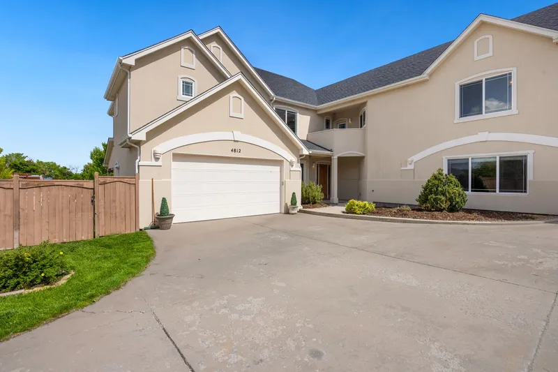 Suburban house with a double garage entrance and a landscaped front yard