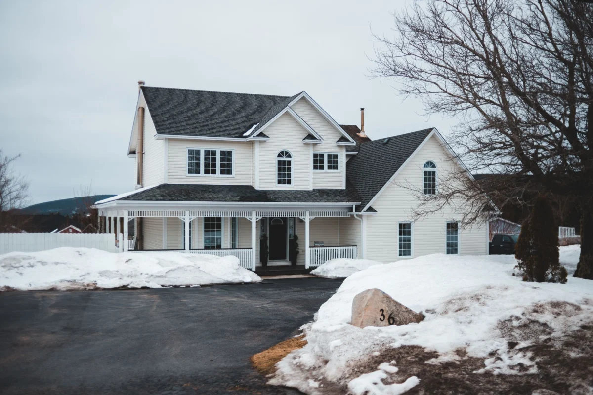 A suburban house surrounded by snow on a winter day
